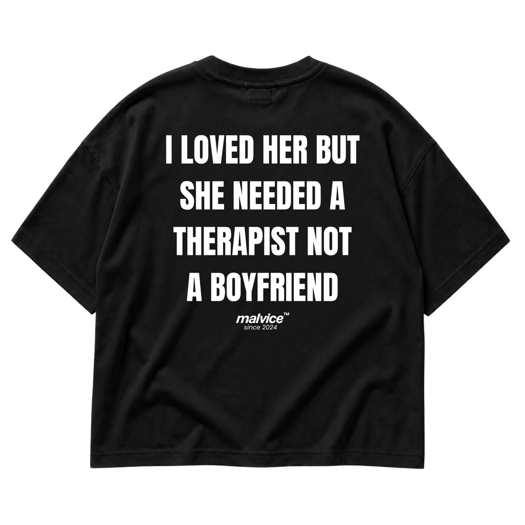 Back view of the black I LOVED HER BUT SHE NEEDED A THERAPIST NOT A BOYFRIEND Oversized T-Shirt by MALVICE.