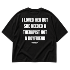 Back view of the black I LOVED HER BUT SHE NEEDED A THERAPIST NOT A BOYFRIEND Oversized T-Shirt by MALVICE.