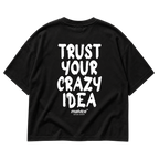 Back view of the black TRUST YOUR CRAZY IDEA Oversized T-Shirt by MALVICE, bold brush lettering.