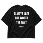Back view of the black ALWAYS LATE BUT WORTH THE WAIT Oversized T-Shirt by MALVICE.
