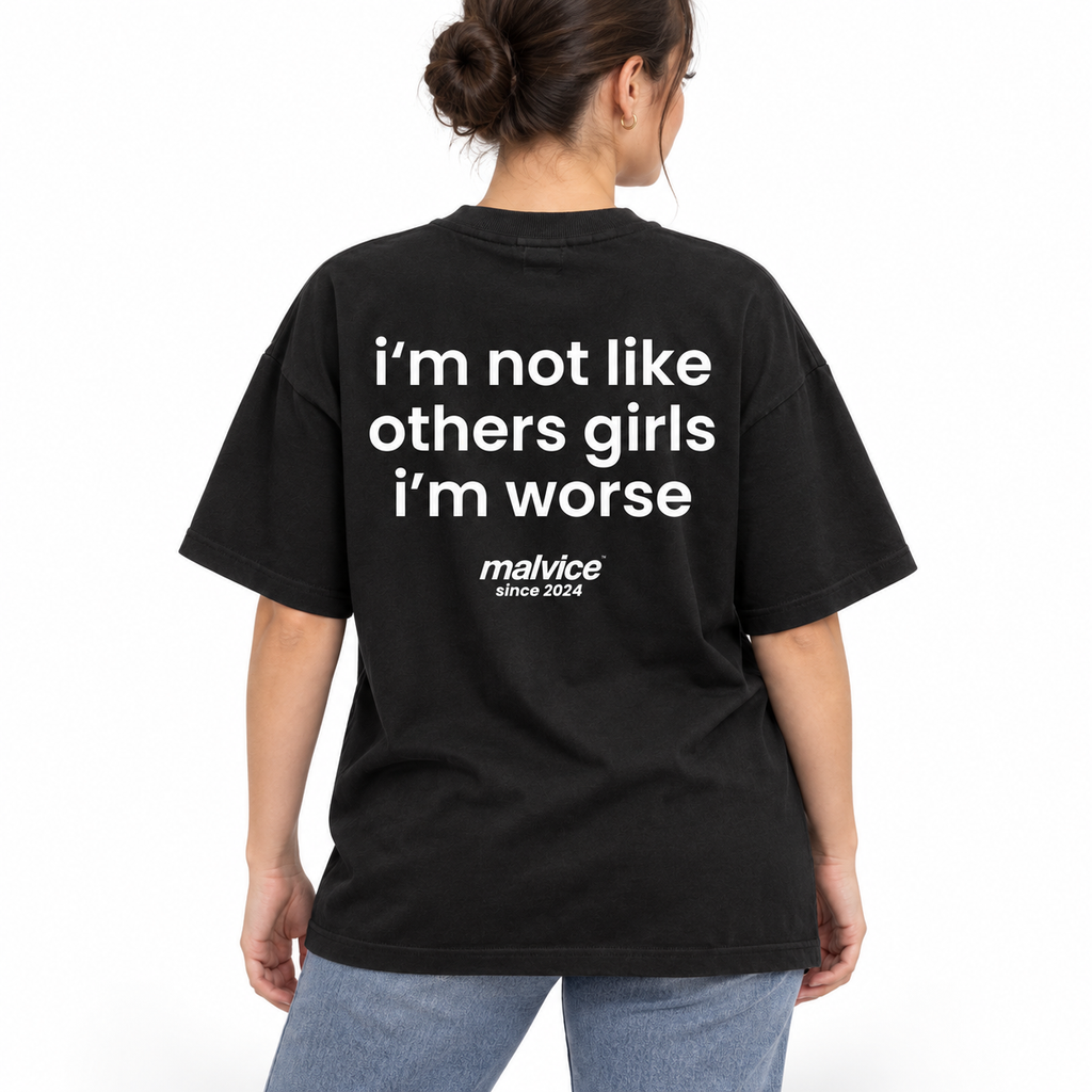 Model wearing the black I'M NOT LIKE OTHER GIRLS I'M WORSE Oversized T-Shirt by MALVICE, back view.