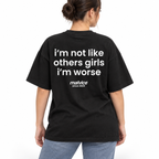 Model wearing the black I'M NOT LIKE OTHER GIRLS I'M WORSE Oversized T-Shirt by MALVICE, back view.