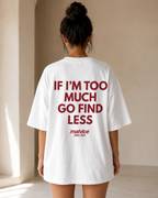 White MALVICE “IF I’M TOO MUCH GO FIND LESS” oversized T-shirt worn in a light room, back view