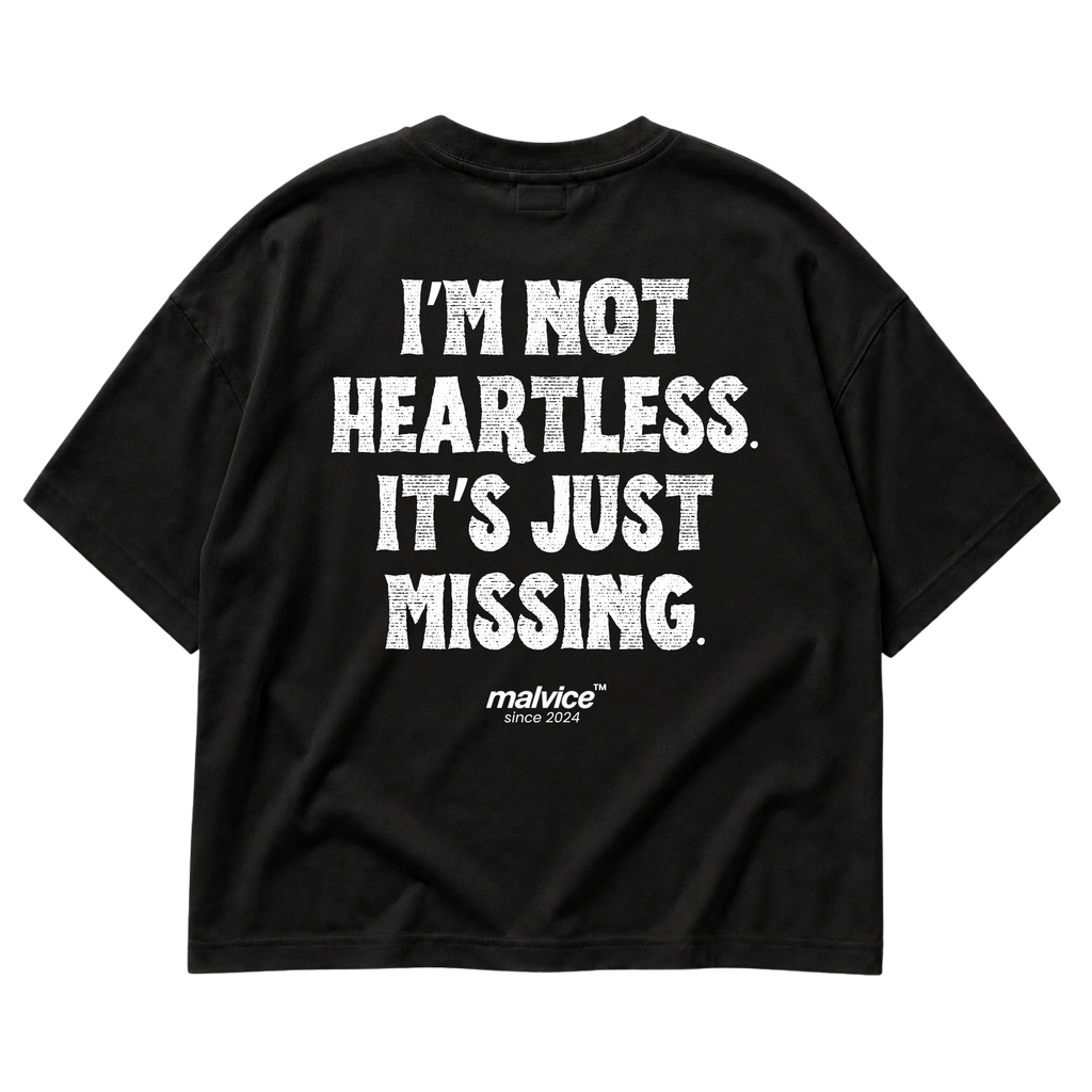 Black MALVICE oversized T-shirt with “I’M NOT HEARTLESS. IT’S JUST MISSING” back print