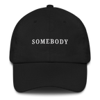 Black MALVICE adjustable dad hat with “SOMEBODY” front embroidery
