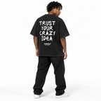 TRUST YOUR CRAZY IDEA Oversized T-Shirt black young adult model back view