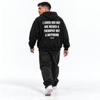I LOVED HER BUT SHE NEEDED A THERAPIST NOT A BOYFRIEND Oversized Hoodie black young adult model back view
