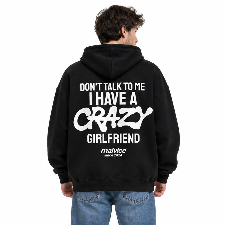 DON'T TALK TO ME I HAVE A CRAZY GIRLFRIEND Oversized Hoodie — black Hoodie on man model, white studio