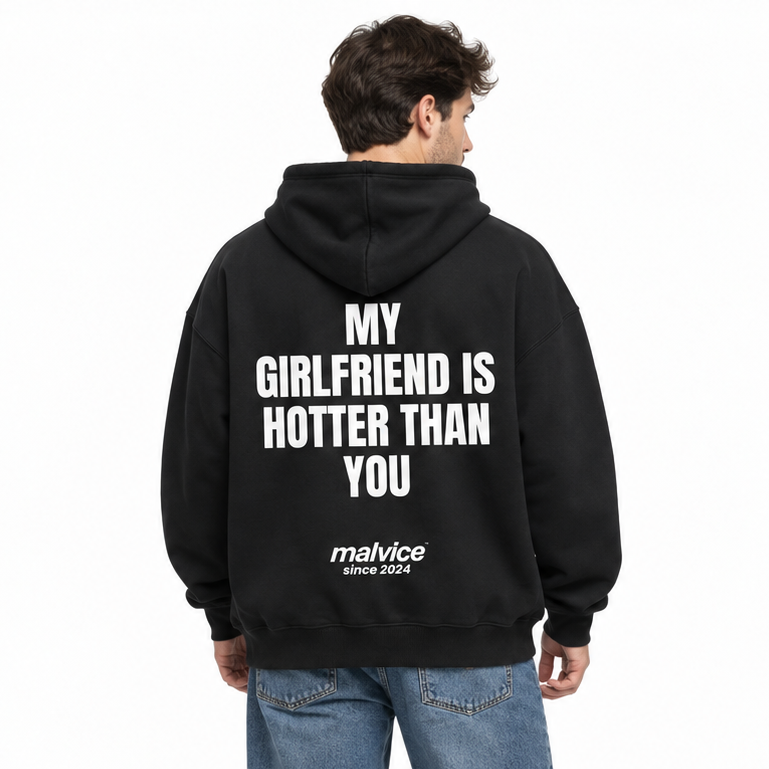 MY GIRLFRIEND IS HOTTER THAN YOU Oversized Hoodie — black Hoodie on man model, white studio