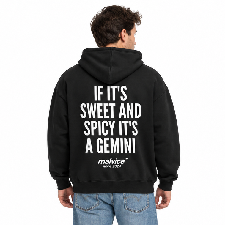 IF IT'S SWEET AND SPICY IT'S A GEMINI Oversized Hoodie — black Hoodie on man model, white studio