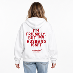 I'M FRIENDLY, BUT MY HUSBAND ISN'T Oversized Hoodie — white Hoodie on woman model, white studio
