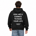 GIVE ME A CHANCE TO RUIN YOUR LIFE Oversized Hoodie — black Hoodie on man model, white studio