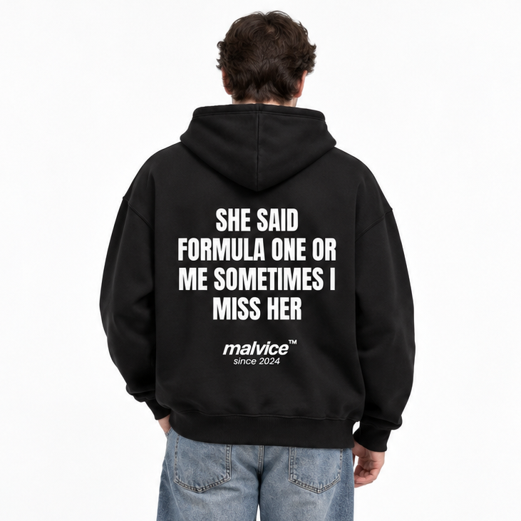 SHE SAID FORMULA ONE OR ME SOMETIMES I MISS HER Oversized Hoodie — black Hoodie on man model, white studio