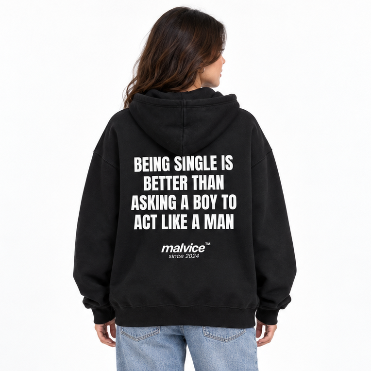 BEING SINGLE IS BETTER THAN ASKING A BOY TO ACT LIKE A MAN Oversized Hoodie — black Hoodie on woman model, white studio