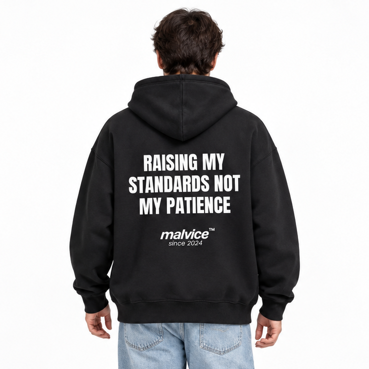 RAISING MY STANDARDS NOT MY PATIENCE Oversized Hoodie — black Hoodie on man model, white studio