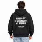 RAISING MY STANDARDS NOT MY PATIENCE Oversized Hoodie — black Hoodie on man model, white studio