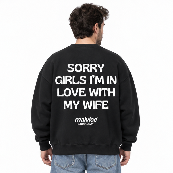 SORRY GIRLS I’M IN LOVE WITH MY WIFE Oversized Sweatshirt — black Sweatshirt on man model, white studio