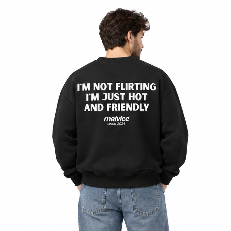 I'M NOT FLIRTING I'M JUST HOT AND FRIENDLY Oversized Sweatshirt — black Sweatshirt on man model, white studio
