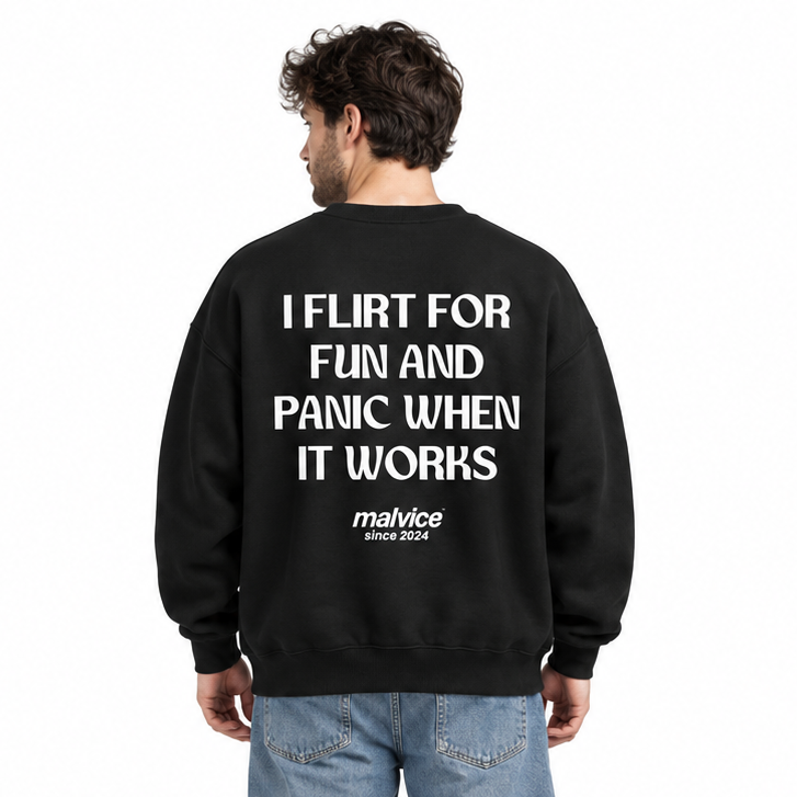 I FLIRT FOR FUN AND PANIC WHEN IT WORKS Oversized Sweatshirt — black Sweatshirt on man model, white studio