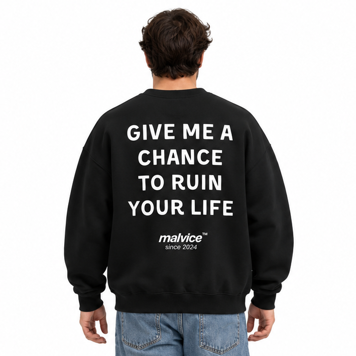 GIVE ME A CHANCE TO RUIN YOUR LIFE Oversized Sweatshirt — black Sweatshirt on man model, white studio