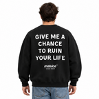 GIVE ME A CHANCE TO RUIN YOUR LIFE Oversized Sweatshirt — black Sweatshirt on man model, white studio