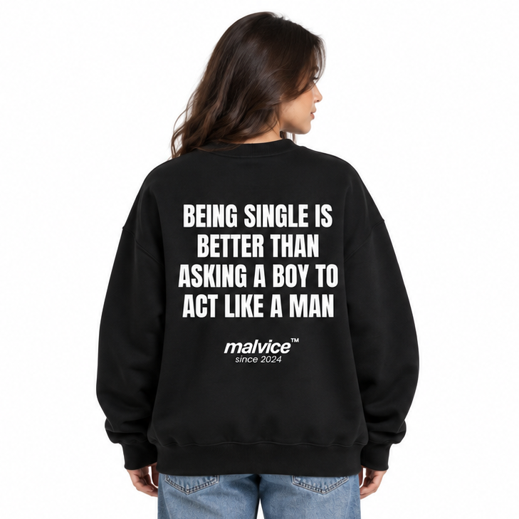 BEING SINGLE IS BETTER THAN ASKING A BOY TO ACT LIKE A MAN Oversized Sweatshirt — black Sweatshirt on woman model, white studio