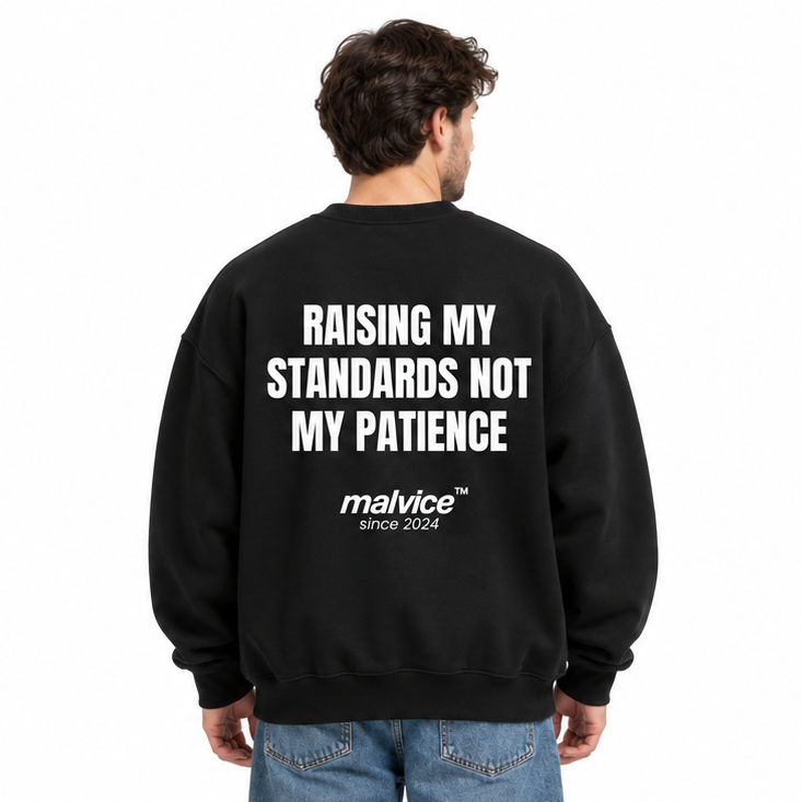 RAISING MY STANDARDS NOT MY PATIENCE Oversized Sweatshirt — black Sweatshirt on man model, white studio
