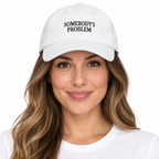 SOMEBODY'S PROBLEM Adjustable Dad Hat — white Cap on woman model, white studio