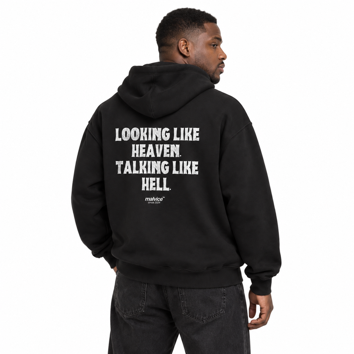 MALVICE N002 — LOOKING LIKE HEAVEN. TALKING LIKE HELL Oversized Hoodie — male model wearing black hoodie, back view, white studio
