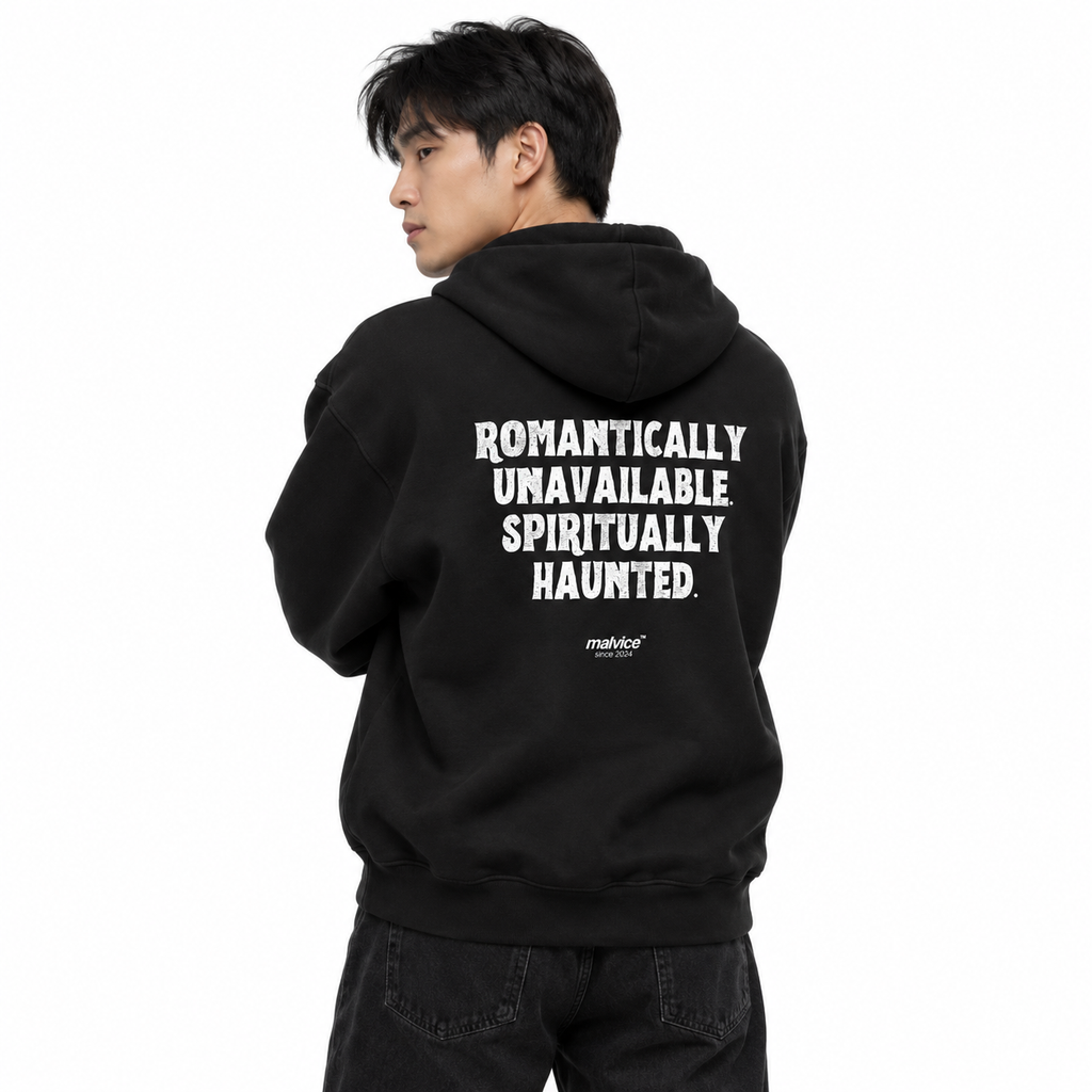 MALVICE N008 — ROMANTICALLY UNAVAILABLE. SPIRITUALLY HAUNTED Oversized Hoodie — male model wearing black hoodie, back view, white studio
