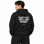 N011 SCARY? WAIT UNTIL I LOSE INTEREST Oversized Hoodie — black hoodie on male model, white studio — MALVICE