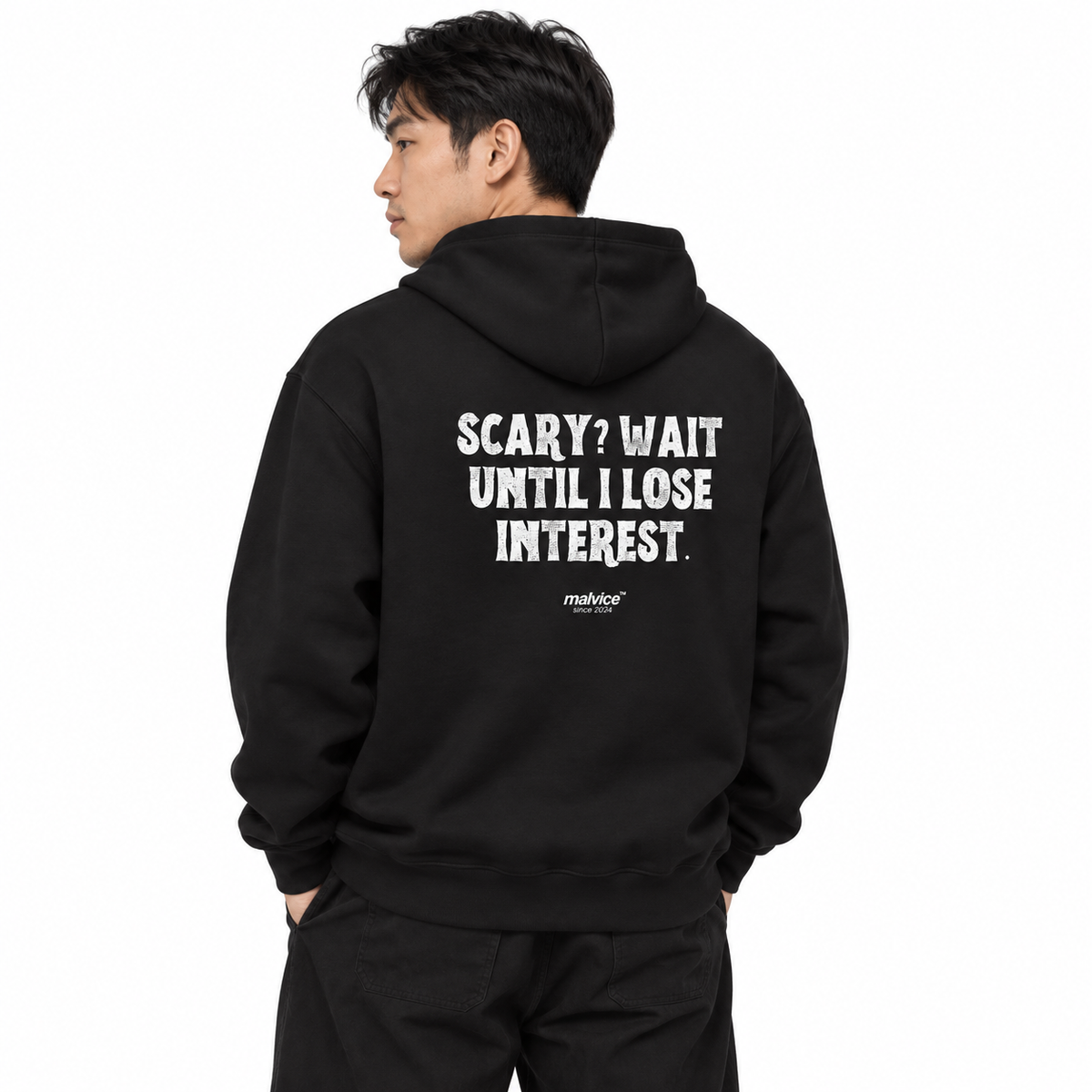 N011 SCARY? WAIT UNTIL I LOSE INTEREST Oversized Hoodie — black hoodie on male model, white studio — MALVICE