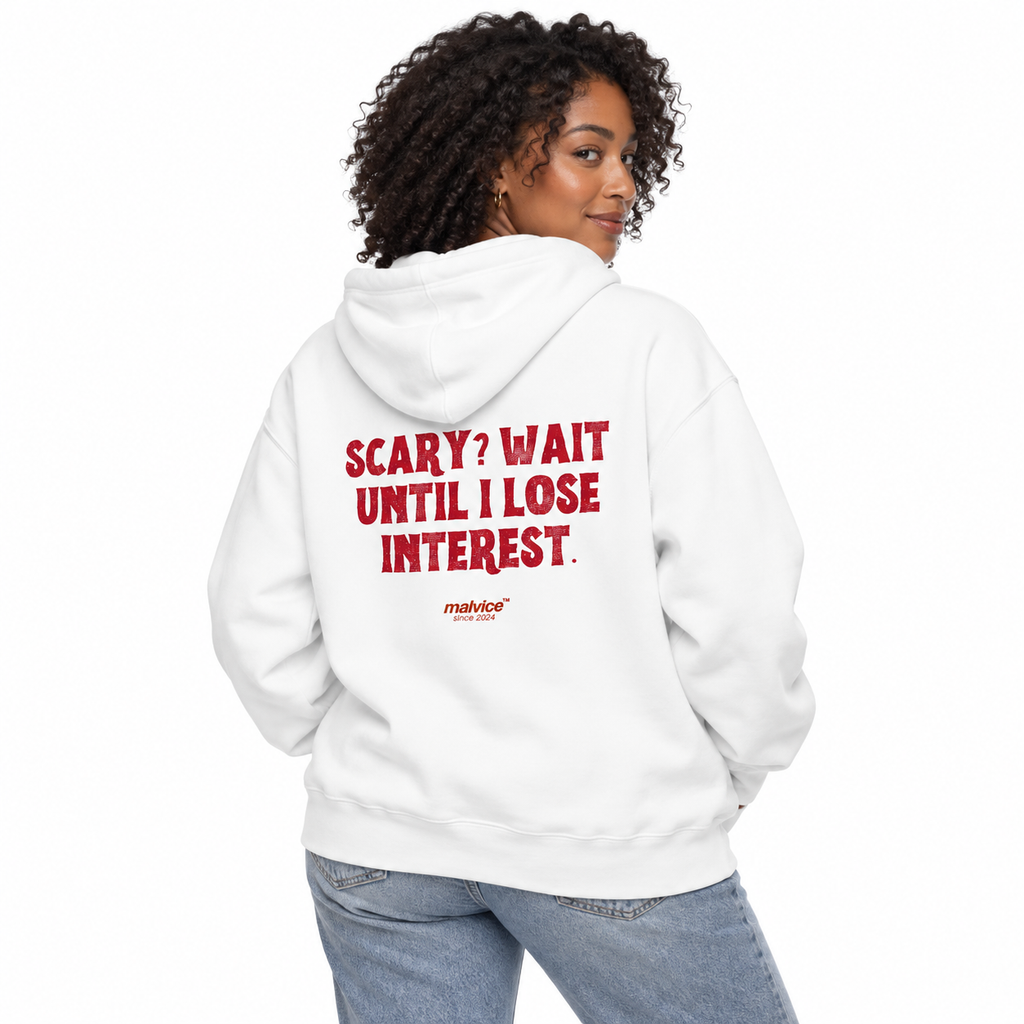 N011 SCARY? WAIT UNTIL I LOSE INTEREST Oversized Hoodie — white hoodie on female model, white studio — MALVICE
