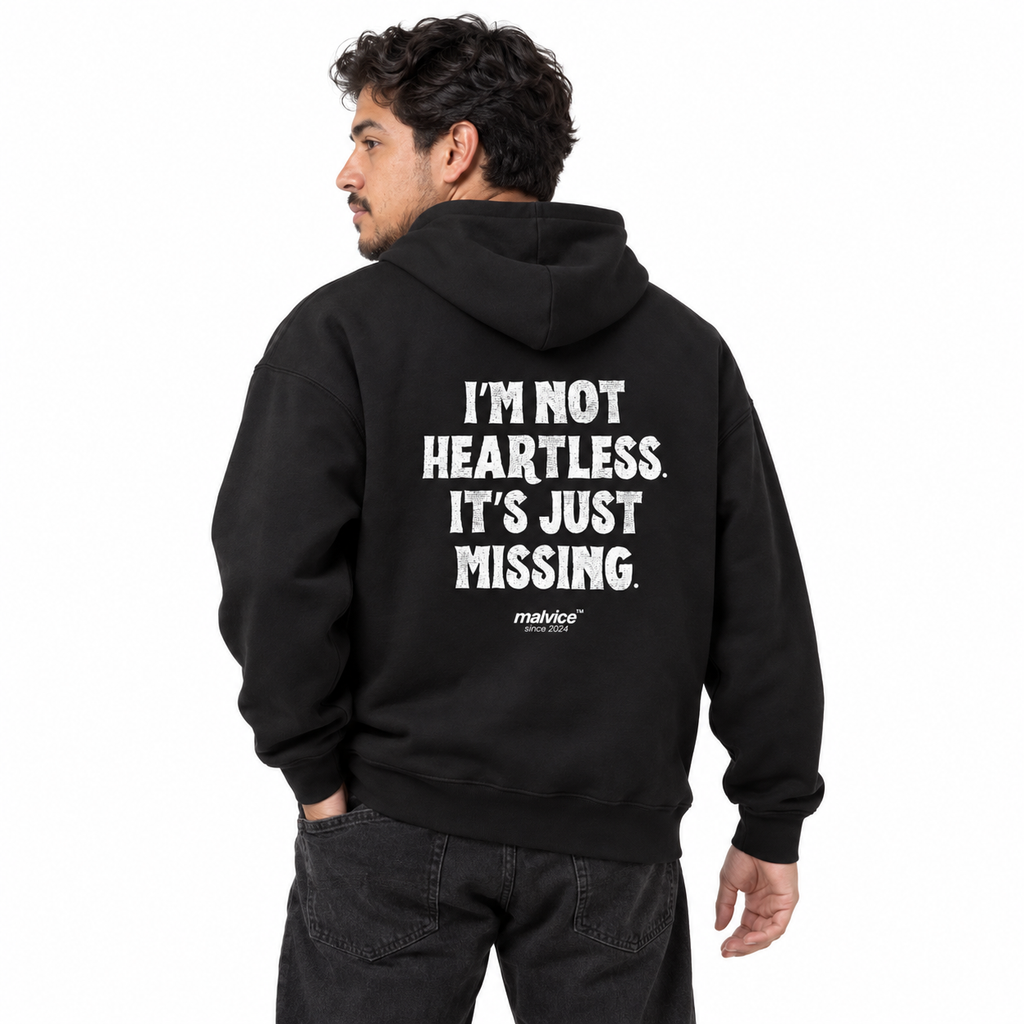 N014 I’M NOT HEARTLESS. IT’S JUST MISSING Oversized Hoodie — black hoodie on male model, white studio — MALVICE