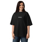 Model wearing a black MALVICE organic oversized T-shirt, front view